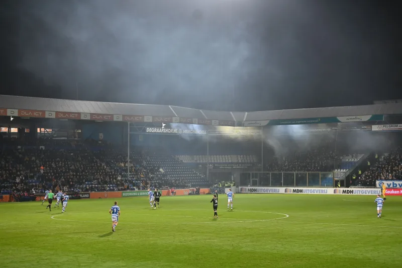 Football match under stadium floodlights in the evening