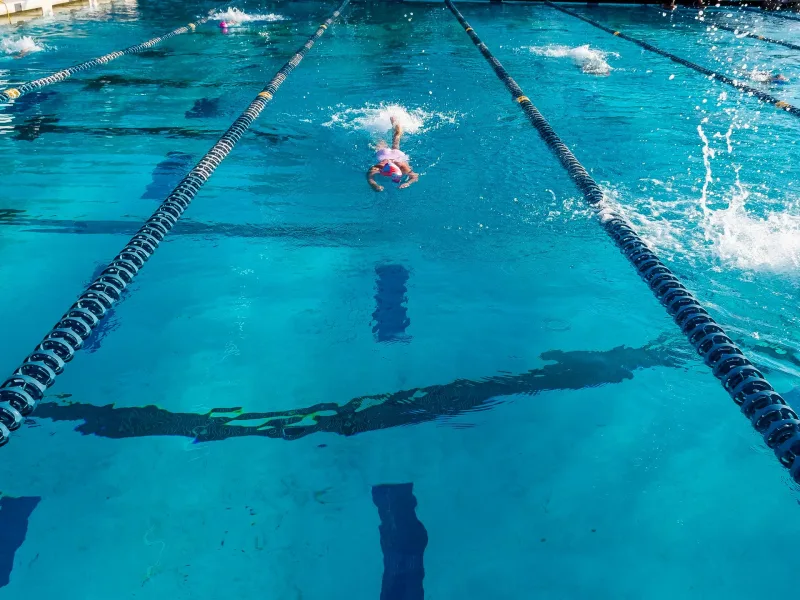 Swimmer training in an outdoor pool lane